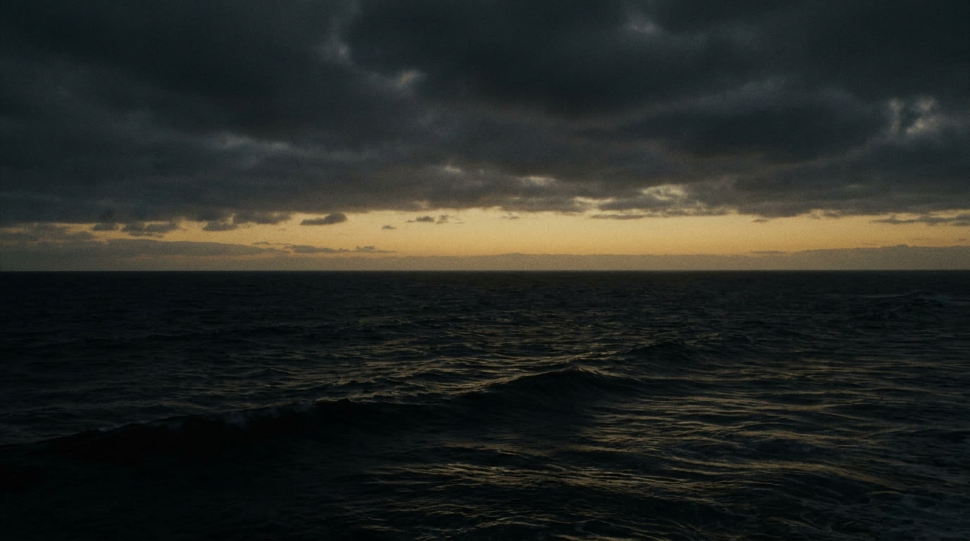 Pre-dawn ocean under a first band of gold light